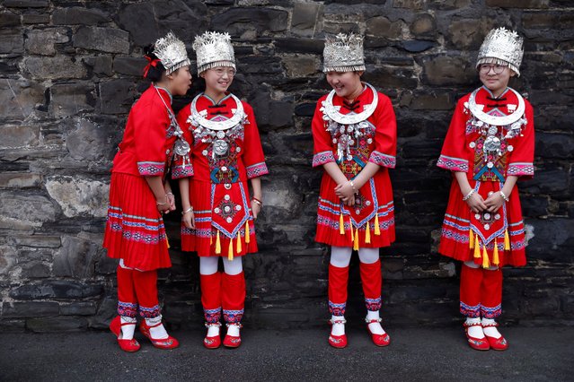 Children of Hill Street family resource centre Kate Wang 11, Kai Xin Zheng 11, Ayla Zheng 9 and Leo Yi Ye 10 chat while dressed in the traditional clothing of the Miao ethnic group of China to welcome the Lunar New Year community celebration of the year of the snake, in Dublin, Ireland on January 20, 2025. (Photo by Clodagh Kilcoyne/Reuters)