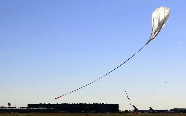 The weather was fine Sunday, and the capsule and attached helium balloon carrying Baumgartner lifts off as scheduled. (Photo by Ross D. Franklin/Associated Press)