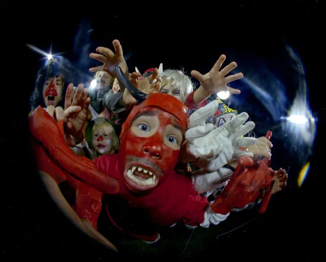 Kids in Halloween costumes are seen through a fisheye lens, October 31, 1966. Location is unknown. (Photo by AP Photo)