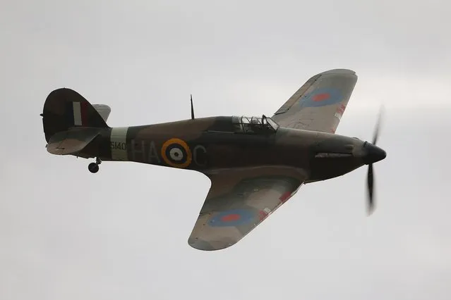 A Hawker Hurricane Mk XIIa 5711 (G-HURI) fighter aircraft performs an aerobatic display at the IWM Duxford on October 18, 2012 in Duxford, England. The aeroplane, similar to those that defended British shores during the Battle of Britain in World War II, is due to be auctioned by Bonhams in their sale of “Collectors' Motor Cars and Automobilia” at Mercedes-Benz World Brooklands on December 3, 2012. The plane was built in 1942 and joined the Royal Canadian Air Force the following year, where it remained for the duration of the war, it is expected to fetch up to 17 million GBP.  (Photo by Oli Scarff)