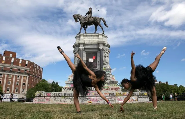 Ballerinas Kennedy George, 14, and Ava Holloway, 14, pose in front of a monument of Confederate general Robert E. Lee after Virginia Governor Ralph Northam ordered its removal after widespread civil unrest following the death in Minneapolis police custody of George Floyd, in Richmond, Virginia, U.S. June 5, 2020. (Photo by Julia Rendleman/Reuters)