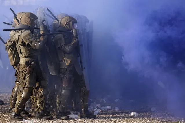 EUFOR (European Force) troops clash with protesters during an exercise “EUFOR Quick Response 2022” in Butmir base, in Sarajevo, Bosnia, Monday, October 24, 2022. (Photo by Armin Durgut/AP Photo)