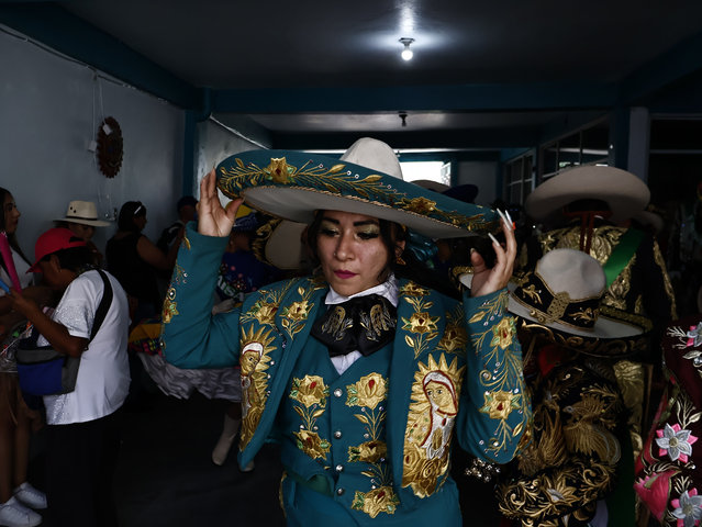 A woman in a hand-embroidered charro suit adjusts her hat before the start of carnival in Santa Martha Acatitla in Mexico City, Mexico on March 2, 2025, the town that kicks off the celebrations that will lead up to Ash Wednesday and the start of Lent. (Photo by Josue Perez/Zuma Press Wire/Rex Features/Shutterstock)