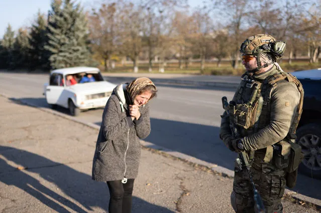 A woman weeps, moments before stepping forward and blessing a Ukrainian soldier in Snihurivka, Ukrainian southern Mykolayiv region on November 10, 2022. (Photo by Andriy Dubchak/Radio Free Europe/Radio Liberty)
