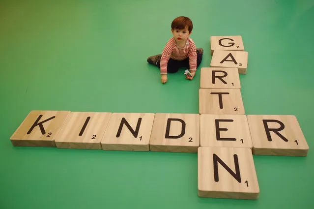 Two-year-old Robby Waley-Cohen plays with artist Carsten Holler's artwork “Gartenkinder” at the Frieze Art Fair in London October 14, 2014. (Photo by Luke MacGregor/Reuters)