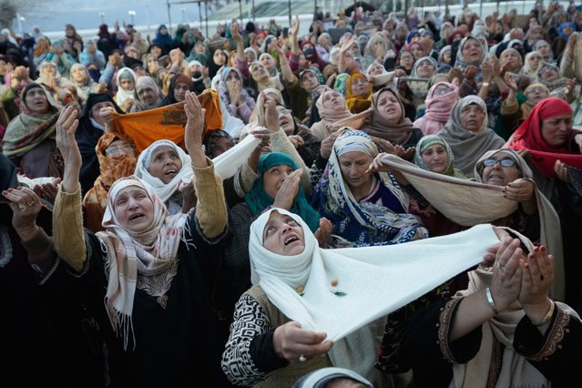 Muslim devotees pray as the head priest displays a holy relic believed to be a hair from the beard of the Prophet Muhammad during special prayers to observe the martyr day of Hazrat Ali, the fourth caliph of Islam, at Hazratbal shrine in Srinagar, Indian controlled Kashmir, Saturday, March 22, 2025. (Photo by Mukhtar Khan/AP Photo)