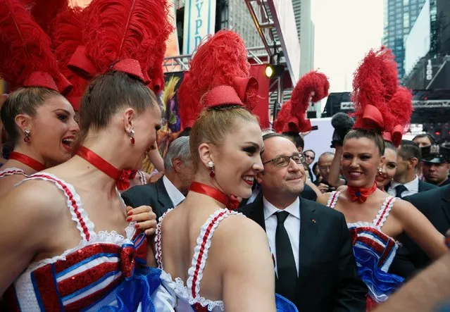 French President Francois Hollande poses for a picture the "Le Moulin rouge" girls during a visit at the "French savoir-faire" fair on Broadway as part of the 70th United Nations General Assembly, in New York September 27, 2015. (Photo by Alain Jocard/Reuters)