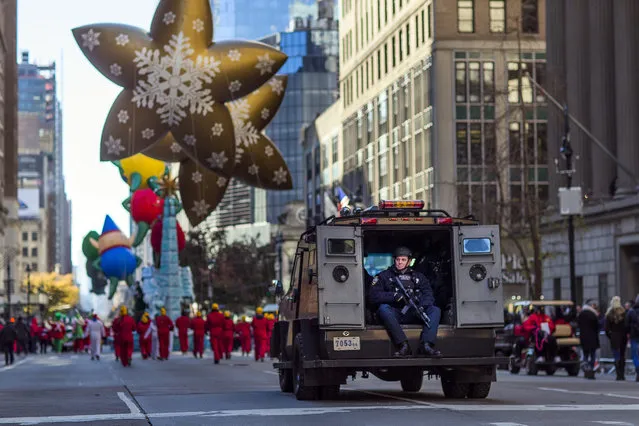 Heavily armed police patrol the parade route during the Thanksgiving Day parade in New York, on November 23, 2017. (Photo by Andres Kudacki/AP Photo)