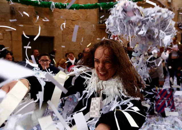 People throw confetti at each other during a band march at the feast marking the shipwreck in 60 A.D. of Saint Paul, Malta's patron saint, in Valletta, Malta, January 27, 2018. (Photo by Darrin Zammit Lupi/Reuters)