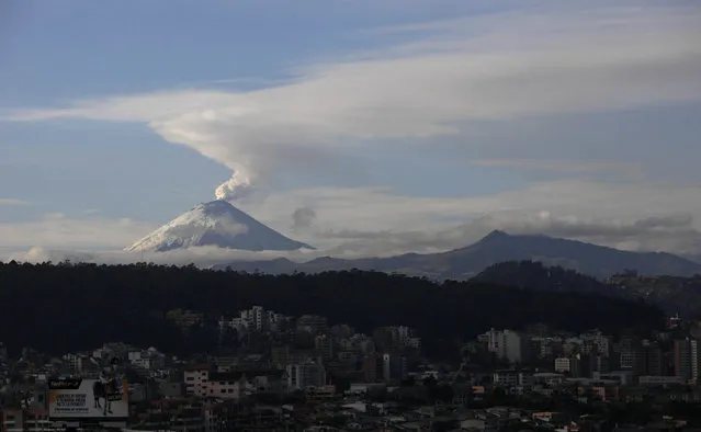 The Cotopaxi volcano spews ash and vapor, seen from Quito, Ecuador, Monday, October 19, 2015. Cotopaxi began showing renewed activity in April and its last major eruption was in 1877. (Photo by Dolores Ochoa/AP Photo)