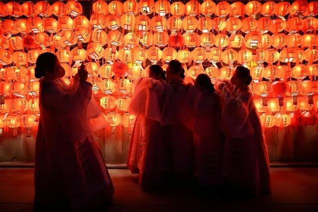 Buddhist faithful take pictures as they celebrate New Year's eve at a temple in Seoul, South Korea on January 1, 2023. (Photo by Kim Hong-Ji/Reuters)