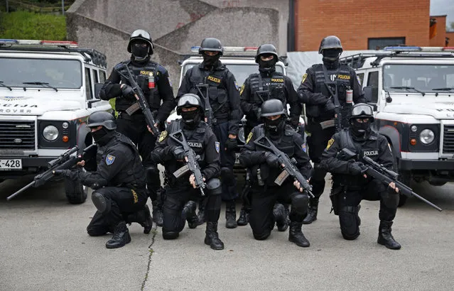 Members of Special Police Support Unit pose for photo in front of their base in central Bosnian town of Zenica, October 3, 2014. In Bosnia, police are permitted to use force ranging from batons to chemical irritants, water cannon, “binding agents, special firearms and explosive devices”, following a warning, but only when other methods of control have proved ineffective, and not against the young, old or disabled unless these use firearms. The method must be “proportional to the resistance or violence coming from the person on whom the force is used”. (Photo by Dado Ruvic/Reuters)