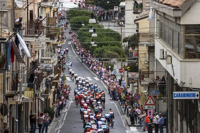 The pack rides through the town of Agira on October 5, 2020 during the 3rd stage of the Giro d'Italia 2020 cycling race, a 150-kilometer route between Enna and volcano Etna, Linguaglossa-Piano Provenzana, Sicily. (Photo by Luca Bettini/AFP Photo)