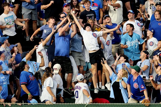 Fans catch a two-run home run hit by Salvador Perez #13 of the Kansas City Royals during the fourth inning at Wrigley Field on July 21, 2025 in Chicago, Illinois. (Photo by Michael Reaves/Getty Images)