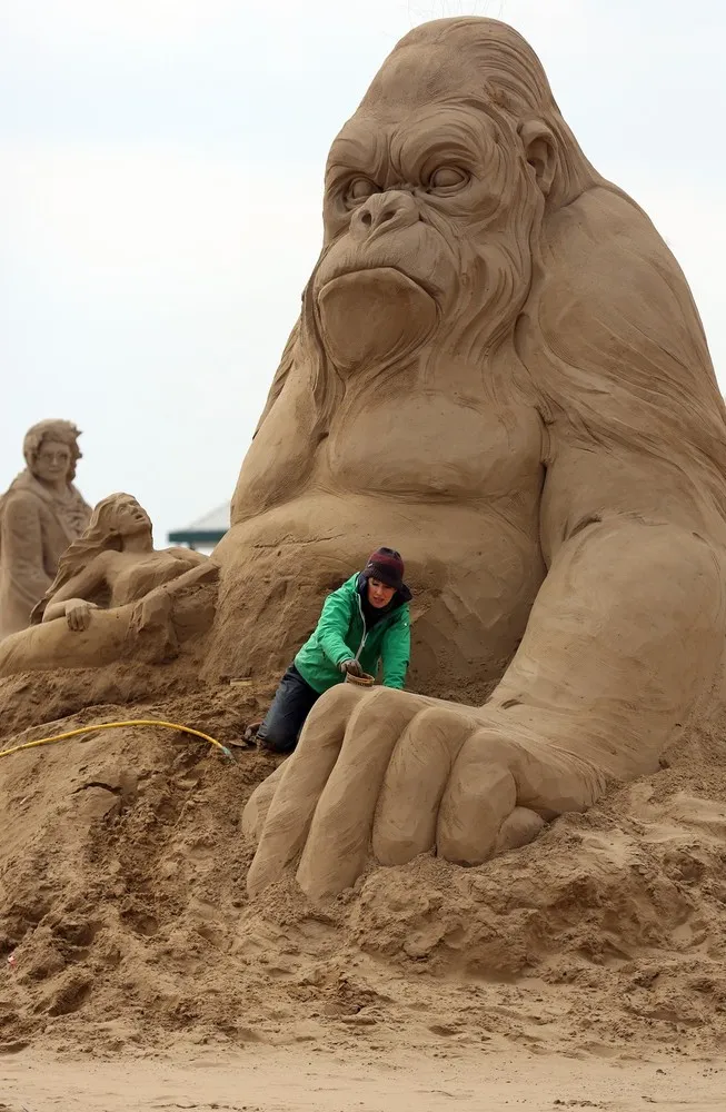 Sculptors Place the Finishing Touches to Their Hollywood Themed Sand Sculptures