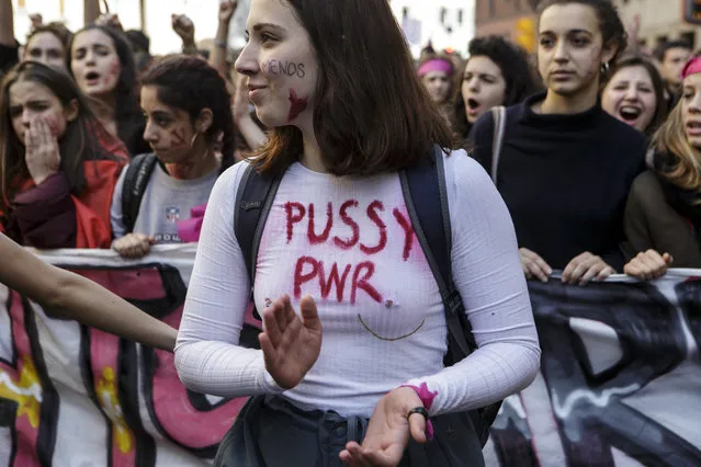 A young woman wearing a t-shirt reading “p*ssy Power” takes part in a rally, demonstrating against gender violence and calling for gender parity on March 8, 2018 in Milan, Italy. International Women's Day is a global day observed on March 8 every year, celebrating the social and political achievements of women. (Photo by Emanuele Cremaschi/Getty Images)