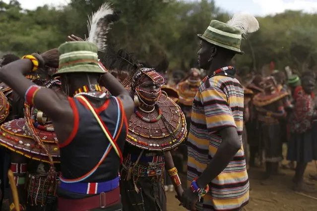 Pokot girls and boys dance together during an initiation ceremony of over a hundred girls passing over into womanhood, about 80 km (50 miles) from the town of Marigat in Baringo County December 6, 2014. (Photo by Siegfried Modola/Reuters)