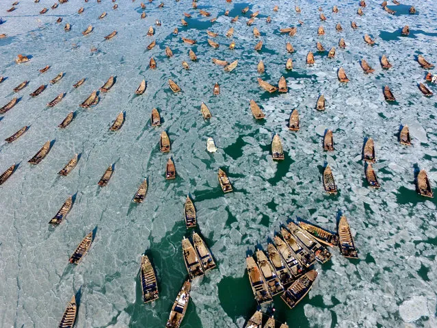 Aerial view of massive fishing boats trapped on the frozen sea in Dalian city, Liaoning province, China on January 25, 2018. (Photo by Imaginechina/Rex Features/Shutterstock)