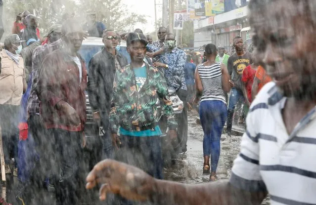 Riot police use water cannons as they clash with supporters of Kenya's opposition leader Raila Odinga of the Azimio La Umoja (Declaration of Unity) One Kenya Alliance, as they participate in a nationwide protest over cost of living and President William Ruto's government in Mathare neighbourhood of Nairobi, Kenya on March 20, 2023. (Photo by Thomas Mukoya/Reuters)