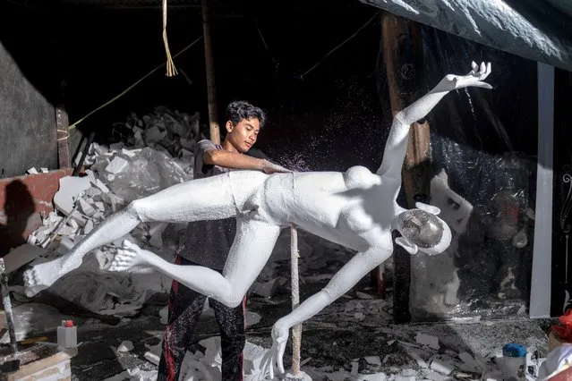 A man creates a body shape of styrofoam ogoh-ogoh on March 9, 2023 at the ogoh-ogoh craft and seller in Denpasar, Bali, Indonesia. Ogoh-ogoh, giant menacing-looking dolls, are paraded through streets a day before Nyepi, the Balinese day of silence. In the last few decades, inorganic material such as polystyrene foam, locally known as styrofoam, has been adopted as the preferred material. Miniatures start at 150,000 Indonesian Rupiah (USD 9); large effigies can sell for as much as IDR 4,000,000 (USD 260). The materials used to make the effigies are highly damaging to the environment and contains possible human carcinogens. Without meaningful recycling, plastic and other waste ends up in landfills or leaks into the ocean instead. In 2015, a global study estimating inputs of plastic waste into the oceans ranked Indonesia as the second largest contributor to plastic marine pollution. In 2017, another study ranked four Indonesian rivers in the worlds most polluting top 20. There has been a growing movement towards the use of environmentally friendly materials and a return to the traditional weaving of bamboo, led by the Balinese youth community. Re-embracing the old method of crafting ogoh-ogoh using eco-friendly and recyclable materials such as plaited bamboo, wood, paper pulps, plastic waste, natural ingredients, and innovation with metal rods, the production process is much longer and involves youth learning the traditional skill of ngulat (weaving) bamboo strips. This method is not only more eco-friendly but also more effective at building a sense of camaraderie and raising awareness about protecting the environment through cultural traditions. (Photo by Agung Parameswara/Getty Images)
