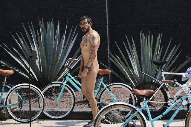 A cyclist attends World Naked Bike Ride day, in Mexico City, Saturday, June 8, 2024. Naked and partially clothed cyclists took to the streets in an effort to promote alternative forms of transportation highlighting the risks of the dependence on fossil fuels and climate change. (Photo by Ginnette Riquelme/AP Photo)