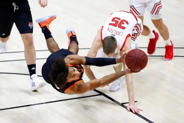 Idaho State guard Robert Ford III, foreground, tries to get a shot off against Utah Utes center Branden Carlson (35)during the first half of an NCAA college basketball game Tuesday, December 8, 2020, in Salt Lake City. (Photo by Jeffrey Swinger/USA TODAY Sports)