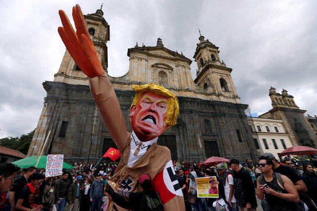 Protesters carry a cutout depicting U.S. President Donald Trump, wearing a Nazi uniform, during a rally commemorating May Day in Bogota, Colombia May 1, 2018. (Photo by Jaime Saldarriaga/Reuters)