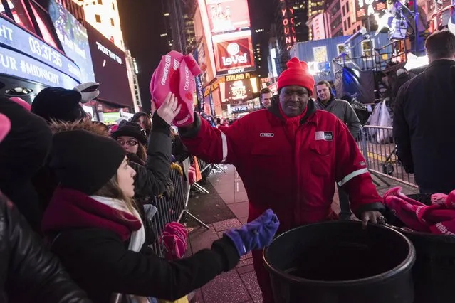 Hats are passed out to revelers in Times Square during New Year's Eve celebrations in New York December 31, 2014. (Photo by Keith Bedford/Reuters)