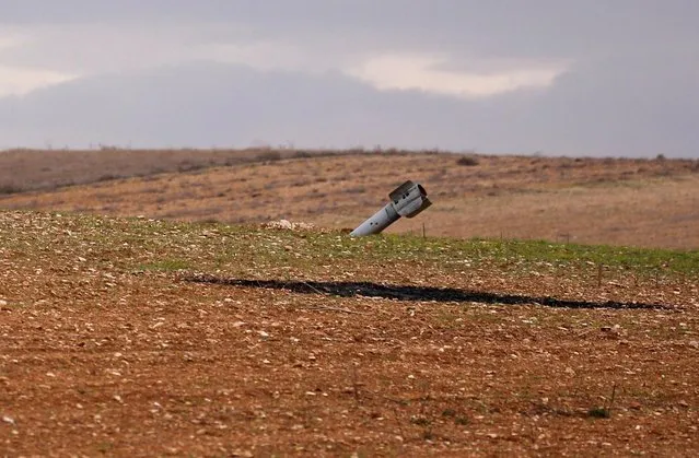 An unexploded missile is seen in a field off the road outside Maarat al-Numan, Syria, January 30, 2020. The town, on the highway joining Aleppo and Damascus, is one of the latest areas to return to government control in the Syrian Army's campaign to regain the last rebel bastion in the country's nearly nine-year-long civil war. (Photo by Omar Sanadiki/Reuters)