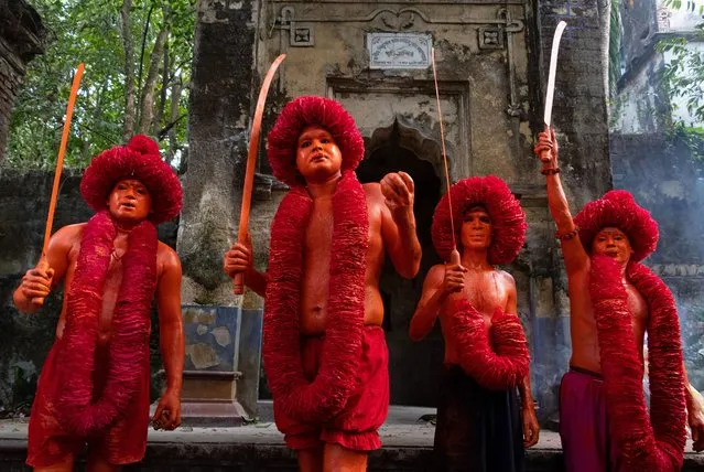 Hindu Devotees took part in the annual Lal Kach (Red Glass) festival in Munshiganj, Bangladesh to welcome Bangla new year on April 12, 2023. During the Hindu Lal Kach festival, children and men paint themselves with orange color and attend a procession holding swords as they show power against evil and welcome the Bengali New Year. The Lal Kach festival is well known for the local community for more than hundred years. As the month of Chaitra, the last in the Bangla year, draws to an end, the Hindu community comes together in a festival dedicated to the worship of Lord Shiva and Parvati. The festival is locally known as “Lal Kach” (Red Glass). The central idea behind this program is for a group of soldiers led by Shiva to appear on earth with a mission: ward off the forces of evil. These soldiers, glowing in the divine light of Shiva, march towards nearby temples. It is all part of a very long tradition going back hundreds of years. The Hindus, especially the young, paint themselves in orange, take up swords, bring out processions and dance. (Photo by Joy Saha/Rex Features/Shutterstock)