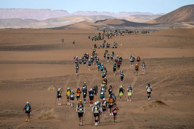 Competitors take part in stage 5 of the 37th edition of the Marathon des Sables between Jdaid and Kourci Dial Zaid in the Moroccan Sahara desert, near Merzouga central Morocco, on April 28, 2023. The 37th edition of the marathon is a live stage 250 kilometres race through a formidable landscape in one of the world's most inhospitable climates. (Photo by Jean-Philippe Ksiazek/AFP Photo)