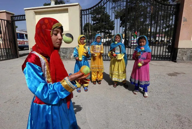 Afghan children juggle during a circus campaign in Herat, Afghanistan, 07 October 2015. The Championship is organized by the Mobile Mini Circus for Children (MMCC), a non-profit organization dedicated to empowering young people, established in 2002, which has grown into a countrywide education program focusing on teaching children to lead. (Photo by Jalil Rezayee/EPA)