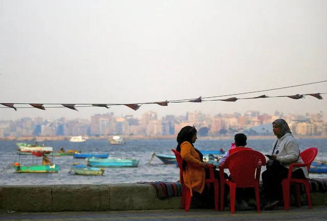 A family sits at a cafe on the shore of the Mediterranean port city of Alexandria, Egypt on May 9, 2023. (Photo by Amr Abdallah Dalsh/Reuters)