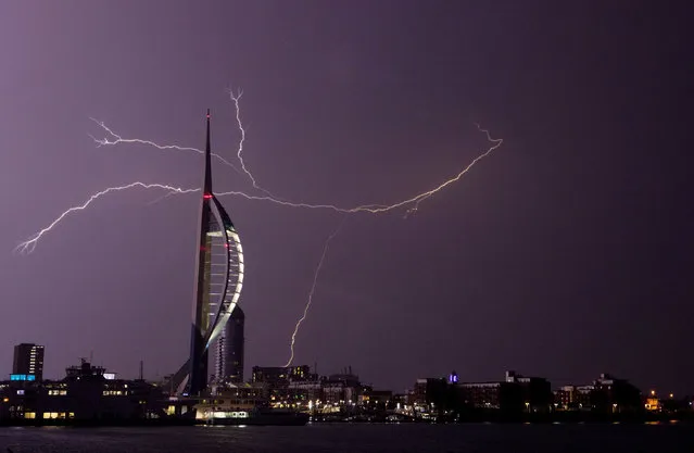 Lightning flashes near the Spinnaker tower in Portsmouth, England on July 19, 2017, as overnight thunderstorms swept across Britain. (Photo by Steve Parsons/PA Wire)