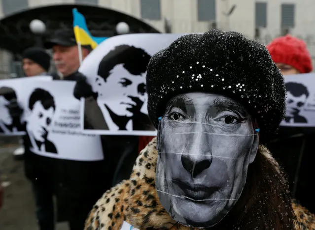 Activists hold a rally demanding to free Roman Sushchenko, an Ukrainian citizen whom Russia's FSB security service detained on the charge of being a spy, as a participant wears a mask depicting Russian President Vladimir Putin in front of the Russian embassy in Kiev, Ukraine, November 2, 2016. (Photo by Valentyn Ogirenko/Reuters)