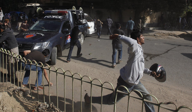 A supporter of Jamiat Talaba Islam (JTI), the student wing of Jamat Islami (JI), throws stones with others at policemen during a protest against satirical French weekly Charlie Hebdo, in Karachi January 16, 2015. (Photo by Akhtar Soomro/Reuters)