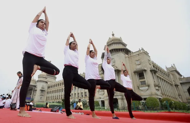 Indian yoga enthusiasts perform yoga in front of Vidhana Soudha, the State Legislature of Karnataka, on the International Day of Yoga, in Bangalore, India, 21 June 2023. The United Nations (UN) has declared 21 June as the International Yoga Day after adopting a resolution proposed by Indian Prime Minister Modi's government. (Photo by Jagadeesh N.V./EPA)