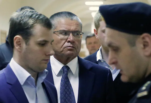 Russian Economy Minister Alexei Ulyukayev who was detained by law enforcement officials on corruption charges, is escorted upon his arrival for a hearing at the Basmanny district court in Moscow, Russia, November 15, 2016. Economic Development Minister Alexei Ulyukayev was arrested late on Monday after he allegedly received a $2m bribe in a sting operation set by the FSB, the KGB's main successor agency, the Investigative Committee said in a statement on Tuesday. The investigators said Ulyukayev, the most senior government official to face charges in years, took the bribe for giving the green light to Rosneft to take part in bidding for another oil company. Ulyukayev, who held the post since 2013 and worked in the government since 2000, denied he is guilty of receiving bribes, an investigator told a court on Tuesday. He is a known liberal figure who has spoken against an increasing government presence in the Russian economy. (Photo by Maxim Shemetov/Reuters)