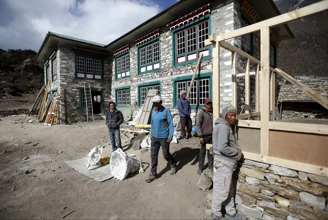 Phurbha Tashi Sherpa (C), 21-time Everest summiteer, walks out from his lodge that is under construction due to damage from the earthquake earlier this year at Khumjung, a typical Sherpa village in Solukhumbu district also known as the Everest region, in this picture taken November 30, 2015. (Photo by Navesh Chitrakar/Reuters)
