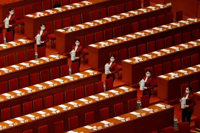 Attendants serve tea before the closing session of the Chinese People's Political Consultative Conference (CPPCC) at the Great Hall of the People in Beijing, China on March 10, 2021. (Photo by Carlos Garcia Rawlins/Reuters)