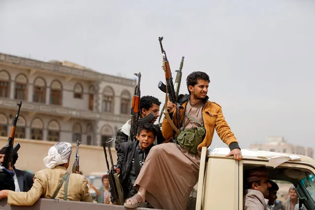 Tribesmen ride on the back of a truck as they attend a tribal gathering to show support to the Houthi movement in Sanaa, Yemen November 10, 2016. (Photo by Khaled Abdullah/Reuters)