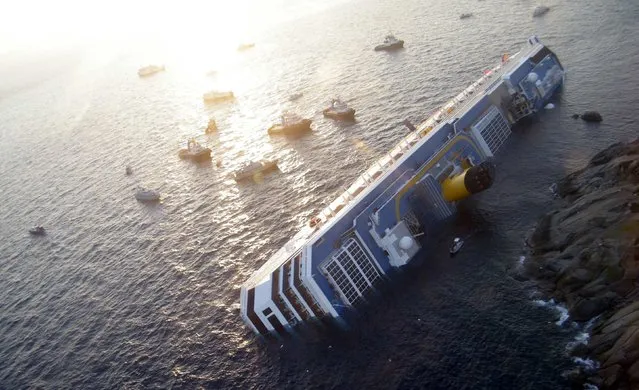 Costa Concordia cruise ship that ran aground is seen off the west coast of Italy at Giglio island in this January 14, 2012 file photo. (Photo by Reuters/Italian Guardia di Finanza)