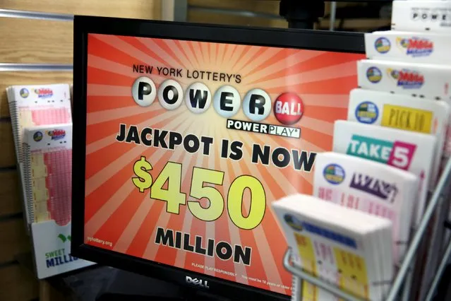 Signage for Powerball is seen in a store in the Manhattan borough of New York January 5, 2016. Powerball's jackpot has surged to an estimated $450 million after the first drawing of the new year resulted in no winning ticket holders, the operator of the multistate game said on Sunday. Powerball, played in 44 states, two U.S. territories and Washington, D.C., will hold its next drawing on Wednesday, giving players another crack at the grand prize. (Photo by Andrew Kelly/Reuters)