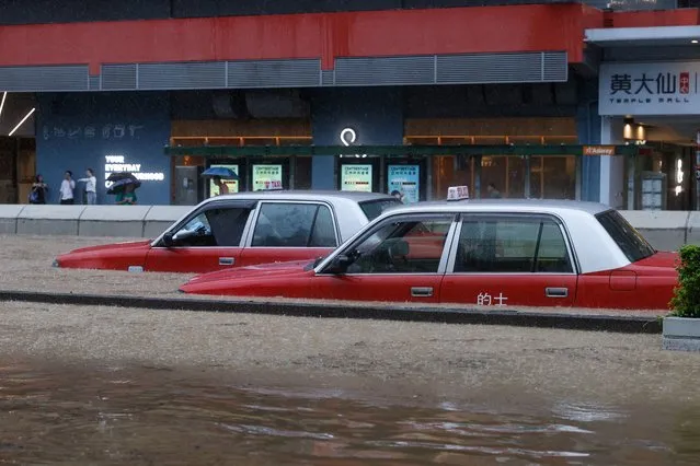 A view of cars partially submerged in flood water following heavy rains, in Hong Kong, China on September 8, 2023. (Photo by Tyrone Siu/Reuters)