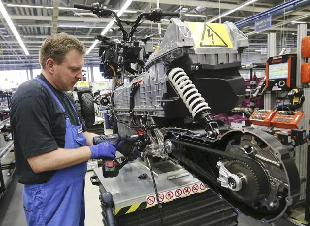 A mechanic assembles a BMW C evolution electric maxi-scooter at the BMW Berlin motorcycle plant February 23, 2015. (Photo by Fabrizio Bensch/Reuters)