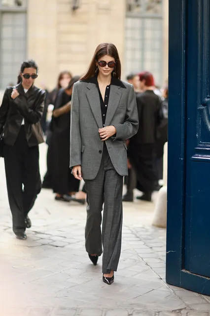American model and actress Kaia Gerber is seen wearing black round sunglasses, long pendant black and gold earrings, a black shirt and a grey oversized blazer outside The Row Fashion show during the Womenswear Spring/Summer 2024 as part of Paris Fashion Week on September 27, 2023 in Paris, France. (Photo by Splash News and Pictures)