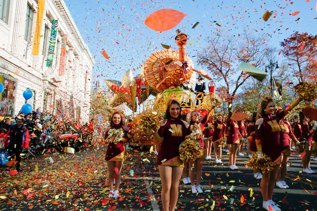 Performers cheer in front of Macy's Tom Turkey float as they take part in the 92nd annual Macy's Thanksgiving Day Parade in New York, Thursday, November 22, 2018. (Photo by Eduardo Munoz Alvarez/AP Photo)