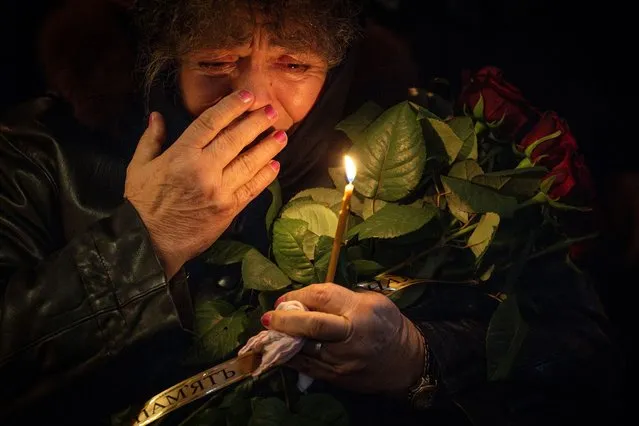 Nina Ivanovna mourns during the funeral of her grandson Serhiy Ikonnikov, a commander of the 72nd Mechanized Infantry Brigade and member of the European Democracy Youth Network, who was killed fighting Russian troops during the attack on Ukraine, at St. Michael's Cathedral in Kyiv on October 19, 2023. (Photo by Thomas Peter/Reuters)