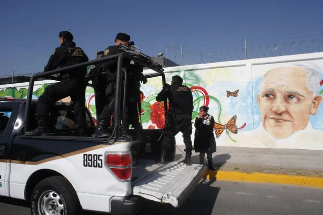 Police drive past a mural of Pope Francis during a security drill along the route the pontiff will take during his upcoming visit to Mexico City, Friday, February 5, 2016. Pope Francis will arrive in Mexico on Feb. 12 and visit several cities. (Photo by Dario Lopez-Mills/AP Photo)