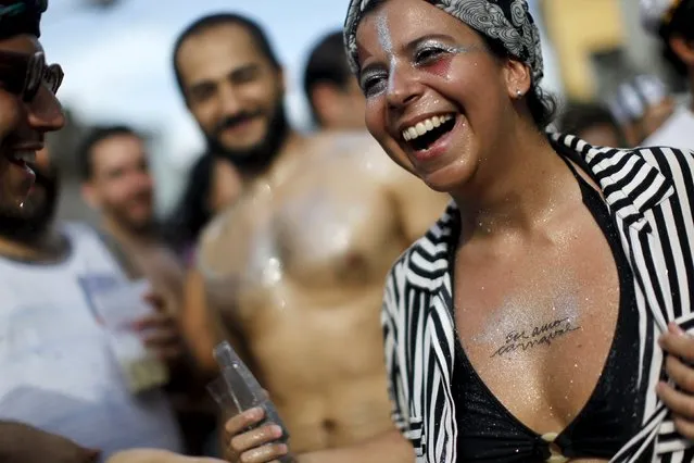 Revellers take part in an annual block party known as “Cordao de Prata Preta”, one of the many carnival parties to take place in the neighbourhoods of Rio de Janeiro, February 6, 2016. The writing on the woman's chest reads “I love carnival”. (Photo by Claudia Daut/Reuters)